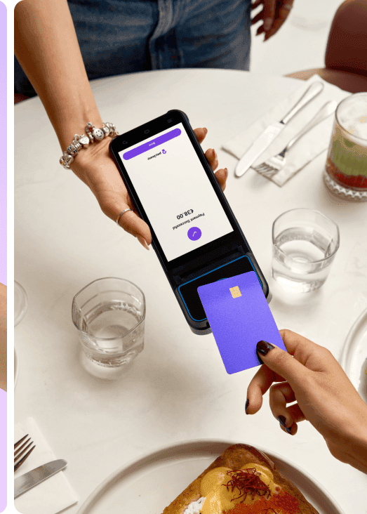 A market stall holder taking a $25.00 contactless card payment on a mobile terminal